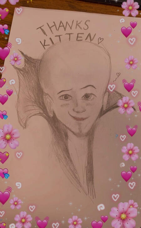 A pencil drawing of a headshot of Overlord Megamind smiling with text above his head that says “Thanks Kitten 💓”.